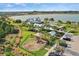 Community aerial view showcasing the playground, clubhouse, swimming pool, and parking at 17549 Timberline Pkwy, Punta Gorda, FL 33982