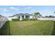 Large backyard with grass, fence, and palm tree at 17549 Timberline Pkwy, Punta Gorda, FL 33982