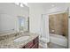 Bright bathroom featuring a granite vanity, toilet, tub, and backyard views at 17549 Timberline Pkwy, Punta Gorda, FL 33982