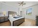 A light-filled bedroom with a queen-size bed, wood-look flooring, and neutral tones at 17549 Timberline Pkwy, Punta Gorda, FL 33982