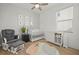 Bright Bedroom showcasing a crib, rocking chair, and a charming round rug at 17549 Timberline Pkwy, Punta Gorda, FL 33982