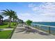 Community boardwalk featuring palm trees and manicured landscaping, with lake view at 17549 Timberline Pkwy, Punta Gorda, FL 33982