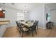 A dining room featuring a large table with seating for eight and light-colored wood flooring at 17549 Timberline Pkwy, Punta Gorda, FL 33982