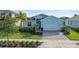 Charming single Gathering home with a two car garage, green lawn and tropical landscaping at 17549 Timberline Pkwy, Punta Gorda, FL 33982