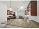 Modern kitchen featuring granite countertops, stainless steel appliances, and a large island with breakfast bar at 17549 Timberline Pkwy, Punta Gorda, FL 33982