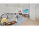 Cozy living room featuring a comfortable sectional sofa, wood floors, and a large television, perfect for relaxation at 17549 Timberline Pkwy, Punta Gorda, FL 33982