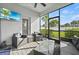 Enclosed patio featuring wicker furniture, a tv, and a view of the fenced yard at 17549 Timberline Pkwy, Punta Gorda, FL 33982