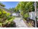 The backyard features a trampoline, a beautiful stone pathway, and lush tropical landscaping at 1815 Grove St, Sarasota, FL 34239