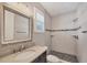Bathroom features modern shower, vanity with granite top, decorative mirror, and plantation shutters at 1815 Grove St, Sarasota, FL 34239