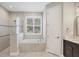 Bathroom features a separate tub, marble countertops, and a glass enclosed shower at 1815 Grove St, Sarasota, FL 34239