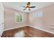 This bedroom features hardwood floors, two windows with plantation shutters, and a ceiling fan at 1815 Grove St, Sarasota, FL 34239