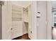 Walk in closet features custom shelving with drawers and hanging space at 1815 Grove St, Sarasota, FL 34239