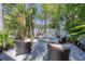 A cozy outdoor fire pit area with comfortable seating surrounded by lush landscaping at 1815 Grove St, Sarasota, FL 34239
