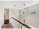 Hallway features hardwood floors, white banisters, a chandelier, and views of the exterior at 1815 Grove St, Sarasota, FL 34239