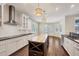 Open kitchen boasts a large island with wine rack, stainless steel appliances, and modern pendant lighting at 1815 Grove St, Sarasota, FL 34239