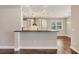Modern kitchen with bar area, stainless steel appliances, and white cabinets at 1815 Grove St, Sarasota, FL 34239