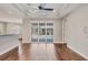 Open floor plan with hardwood floors, ceiling fan, and large sliding doors at 1815 Grove St, Sarasota, FL 34239