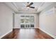 Bright living room with hardwood floors, trey ceilings and glass doors leading to an outdoor pool at 1815 Grove St, Sarasota, FL 34239
