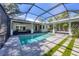 A stunning screened-in pool with an open-air design and an adjoining outdoor living space at 1815 Grove St, Sarasota, FL 34239