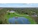 Aerial shot showcasing the pond with a dock and winding driveway leading to the estate at 20307 74Th E Ave, Bradenton, FL 34202