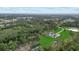 Expansive aerial view of a luxury home situated on acreage surrounded by lush, mature trees at 20307 74Th E Ave, Bradenton, FL 34202