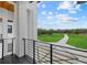 Balcony view showcasing a sprawling green lawn, mature trees, and a long driveway at 20307 74Th E Ave, Bradenton, FL 34202