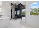 Luxury bathroom featuring a glass enclosed shower, soaking tub, and modern finishes at 20307 74Th E Ave, Bradenton, FL 34202