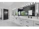 Bright bathroom featuring double vanity with sleek white countertops and black hardware at 20307 74Th E Ave, Bradenton, FL 34202