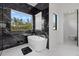 Luxurious bathroom featuring a modern soaking tub and elegant black marble accents at 20307 74Th E Ave, Bradenton, FL 34202