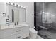 Modern bathroom with marble shower, white vanity, and sleek black fixtures throughout at 20307 74Th E Ave, Bradenton, FL 34202