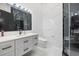 Elegant bathroom featuring marble tile, a sleek vanity, and a modern glass-enclosed shower at 20307 74Th E Ave, Bradenton, FL 34202