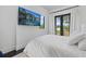 Bright bedroom features neutral tones and black-framed glass patio doors with views of the outdoors at 20307 74Th E Ave, Bradenton, FL 34202
