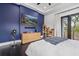 Stylish bedroom featuring dark wood floors, a blue accent wall, and outside access at 20307 74Th E Ave, Bradenton, FL 34202