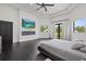Spacious bedroom with dark wood floors, fireplace, television, and views of the outside at 20307 74Th E Ave, Bradenton, FL 34202