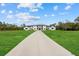 Modern home with black trim and a long driveway leading to the grand entrance at 20307 74Th E Ave, Bradenton, FL 34202