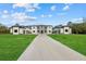 Modern home with black trim and a long driveway leading to the grand entrance at 20307 74Th E Ave, Bradenton, FL 34202