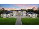 Striking modern exterior featuring a large yard and symmetrical design, perfect for a Gathering at 20307 74Th E Ave, Bradenton, FL 34202