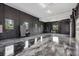 Spacious black and white garage with polished epoxy floors and natural light from several windows at 20307 74Th E Ave, Bradenton, FL 34202
