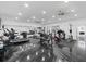 A spacious home gym featuring modern exercise equipment, mirrored walls, and sleek flooring at 20307 74Th E Ave, Bradenton, FL 34202