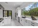 Modern kitchen with stainless steel appliances, white cabinetry, and a scenic view out the window at 20307 74Th E Ave, Bradenton, FL 34202