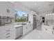 The kitchen features a stainless steel dishwasher, microwave and oven with a scenic view out the window at 20307 74Th E Ave, Bradenton, FL 34202