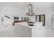 Bright open concept kitchen with a large island, marble countertops, stainless steel appliances, and an attached living space at 20307 74Th E Ave, Bradenton, FL 34202