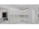 Kitchen features white cabinets, marble countertops, and a doorway into another room with a gray stone floor at 20307 74Th E Ave, Bradenton, FL 34202