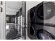 Modern laundry area featuring sleek, front-load, stackable washer and dryer near garage entrance at 20307 74Th E Ave, Bradenton, FL 34202