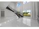 Bright living room with high ceilings, modern staircase, and large windows offering scenic views at 20307 74Th E Ave, Bradenton, FL 34202