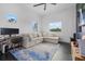 Comfortable living area features a large sectional sofa, TV, and views from three large windows at 20307 74Th E Ave, Bradenton, FL 34202
