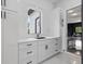 Bright mud room area features white cabinets, marble countertops, and black hardware accents at 20307 74Th E Ave, Bradenton, FL 34202
