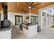 Well equipped outdoor kitchen with bar seating, grill and ceiling fans at 20307 74Th E Ave, Bradenton, FL 34202