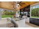 Outdoor kitchen features granite counters, ceiling fans, wood ceiling and stainless steel grill at 20307 74Th E Ave, Bradenton, FL 34202