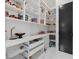 Bright pantry boasting open shelving, storage drawers, and marble-look countertops and backsplash at 20307 74Th E Ave, Bradenton, FL 34202